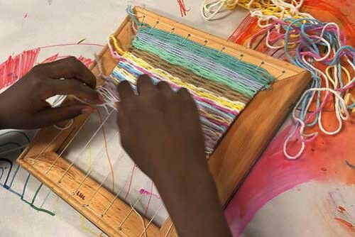 kid doing a weaving craft