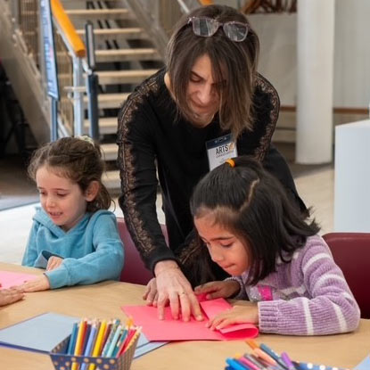 arts Ambassador helping child with art