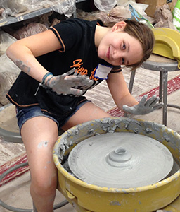 Child using a pottery wheel
